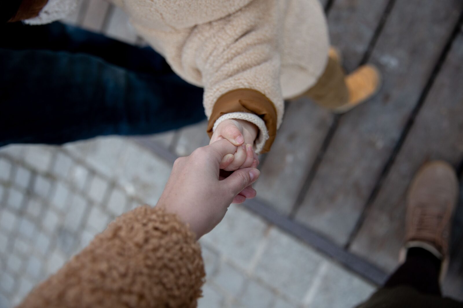Moeder houdt hand vast van kind